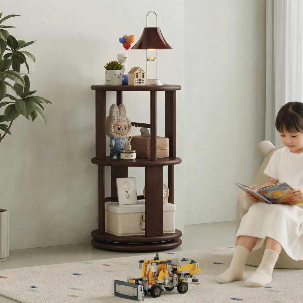 A young girl sits on the floor reading beside a shorter two-tier solid rubber wood rotating bookshelf