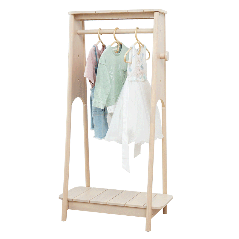 Light wood adjustable kids clothing rack with hanging clothes on a white background