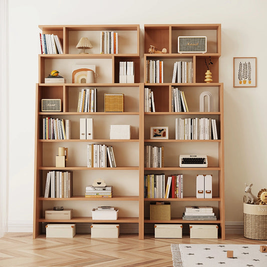Front view of a double ladder bookshelf unit holding books, a speaker, and small baskets