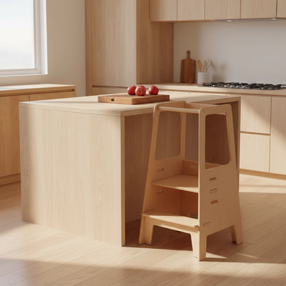 Three-quarter view of the empty birch plywood toddler standing stool in a wood-toned kitchen setting