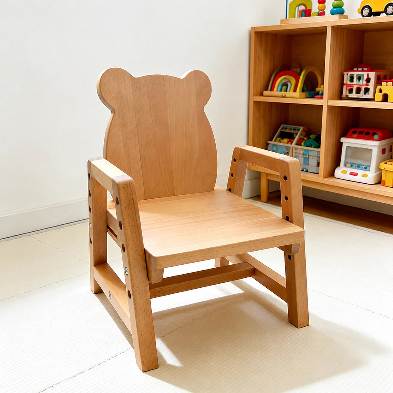 Three-quarter view of a solid beech wood toddler chair featuring a bear-ear backrest in a playroom