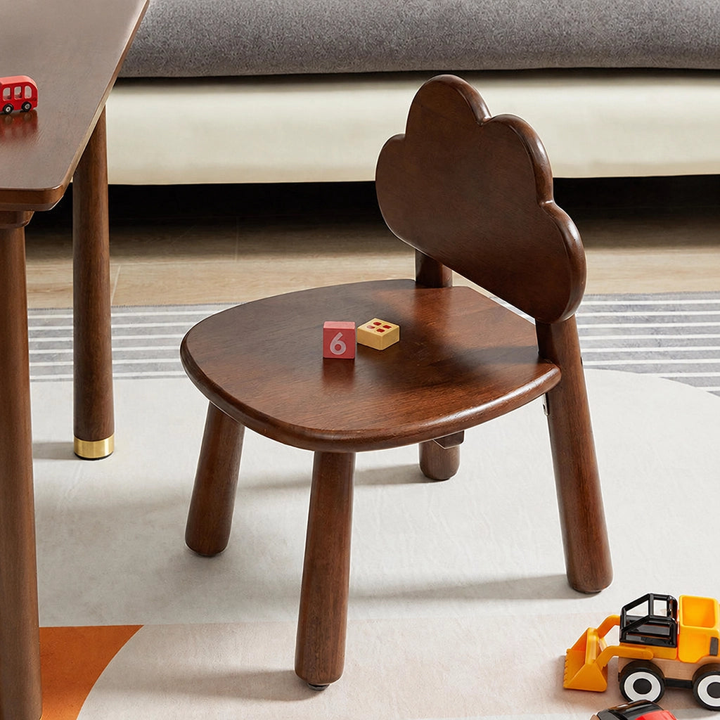 Cloud backrest toddler chair with two toy blocks on the dark wood seat beside a table