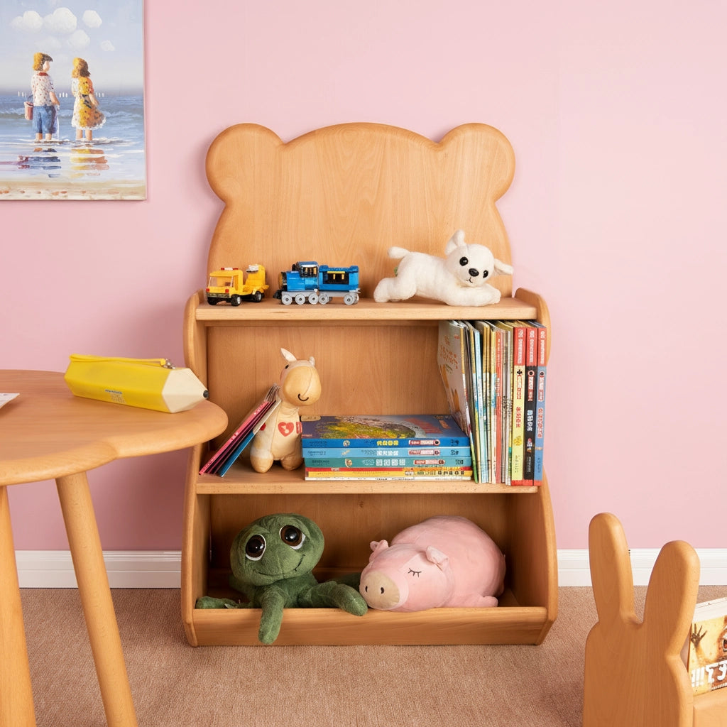 Bear-shaped kids bookshelf holding books and plush toys in a playroom with a pink wall and a children's table
