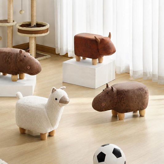 Group display of four children's animal footstools with solid wood legs on a light floor