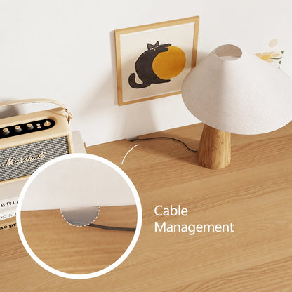Close-up of the cable management cutout on the solid pine desk surface with a lamp cord passing through