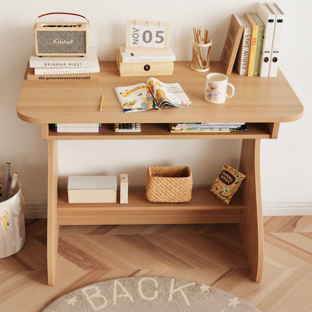Front view of the empty children's study desk displaying books, storage slots, and a bottom shelf