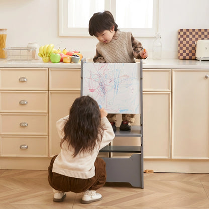 Step stool converted into a children's easel desk with a girl drawing on the whiteboard with chalk