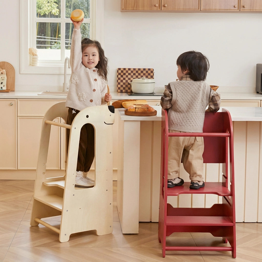 Side view of a girl and boy using helper towers at a counter while holding food in a kitchen setting