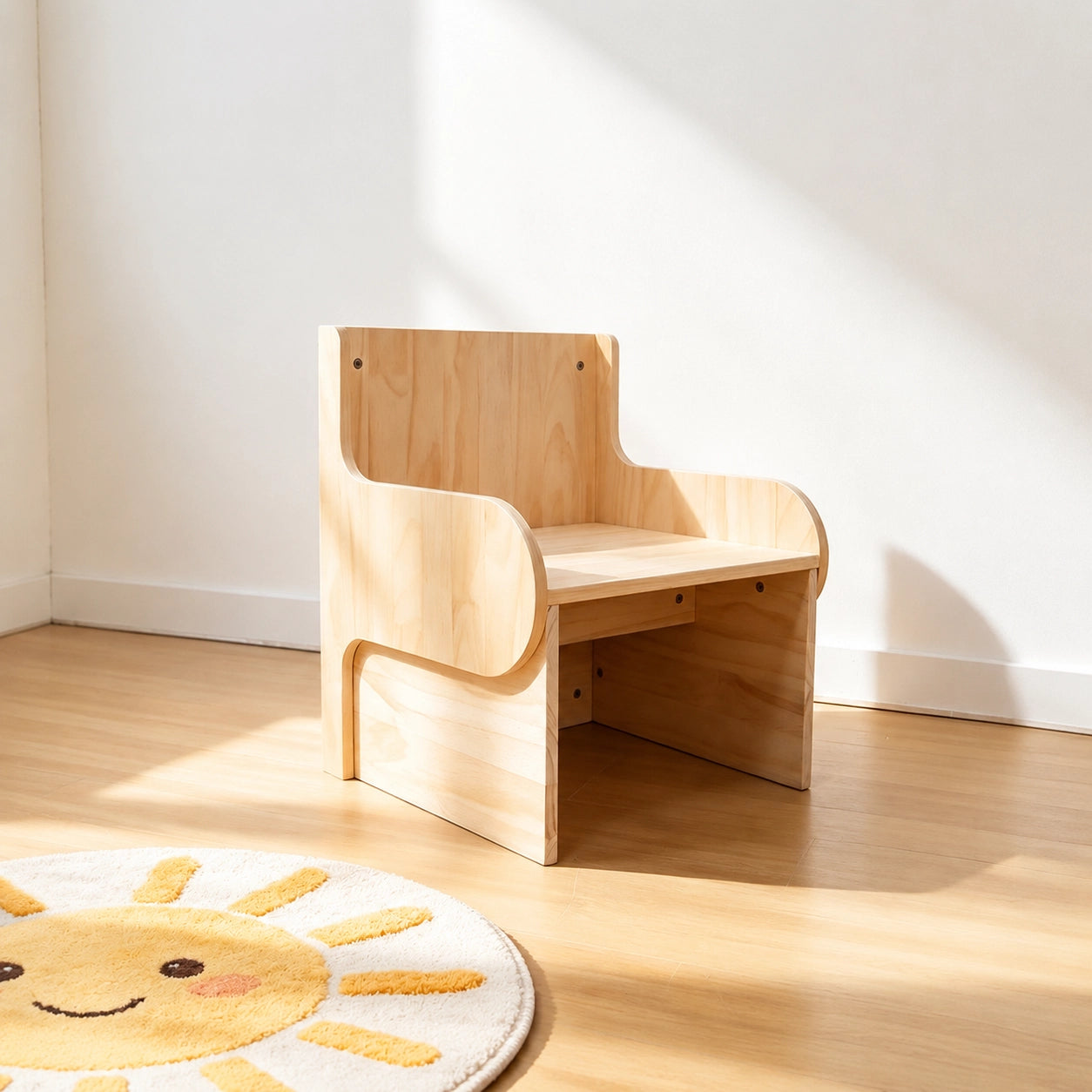 Side view of the solid pine toddler chair on a wooden floor