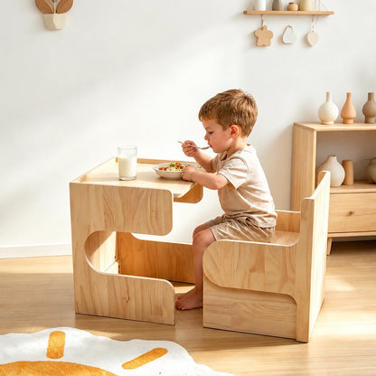 Child sitting on a chair and eating at a solid pine toddler table
