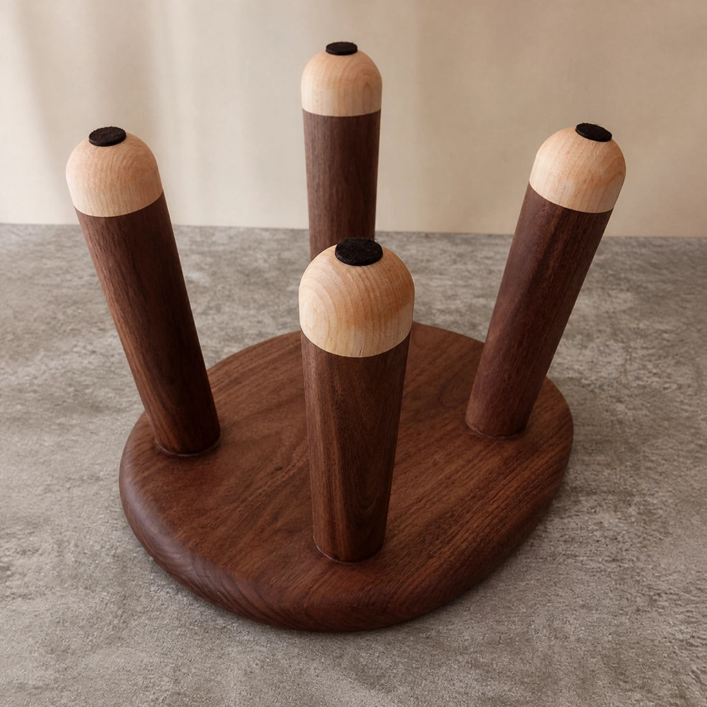 Bottom view of the kids wood stool showing the four legs and round protective pads on the feet