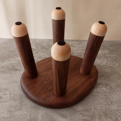 Bottom view of the kids wood stool showing the four legs and round protective pads on the feet
