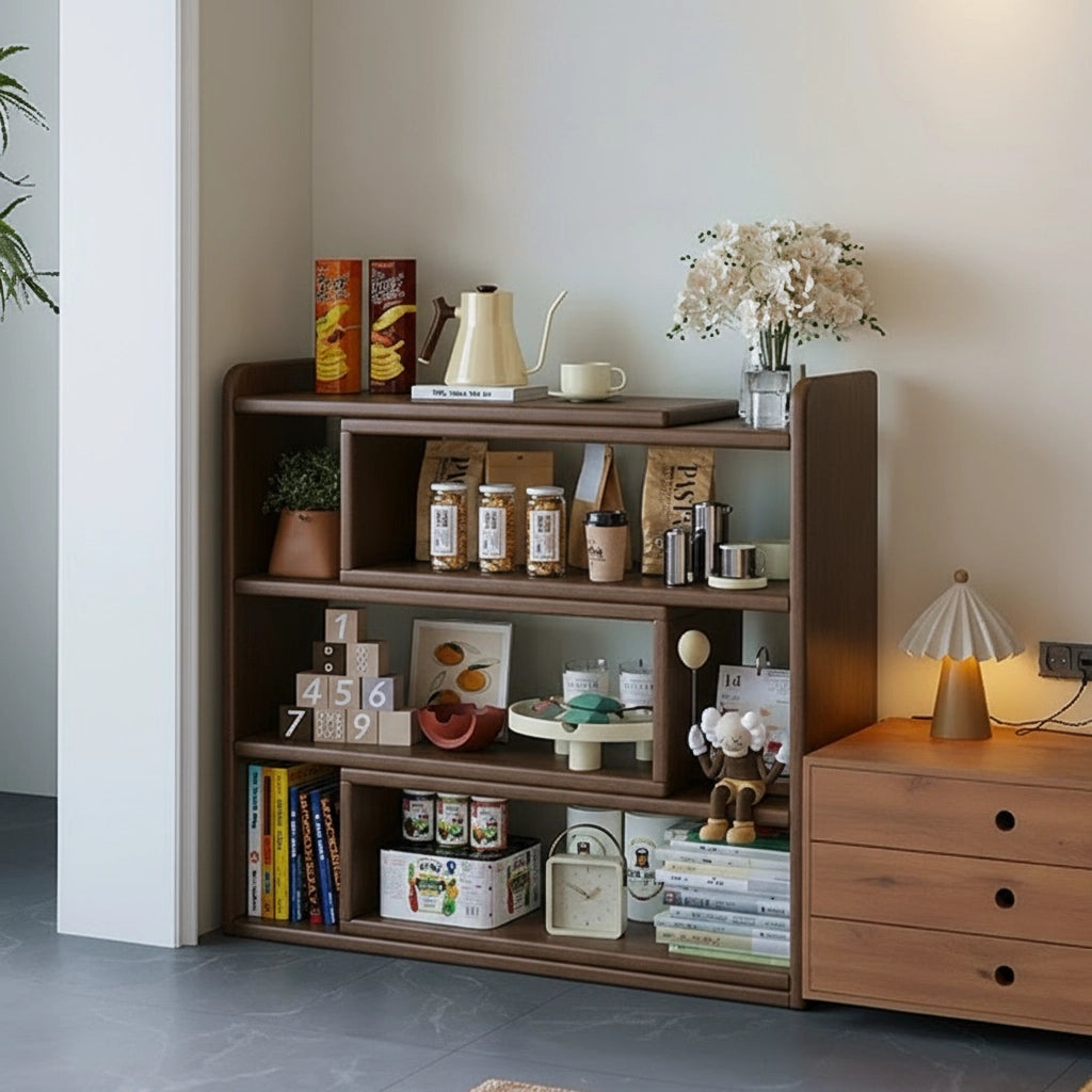 Expandable floor bookshelf filled with jars, toys, and books next to a wooden three-drawer chest