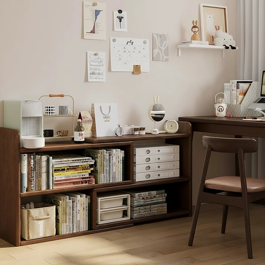 Low solid rubberwood expandable bookshelf positioned next to a study desk and filled with reference binders