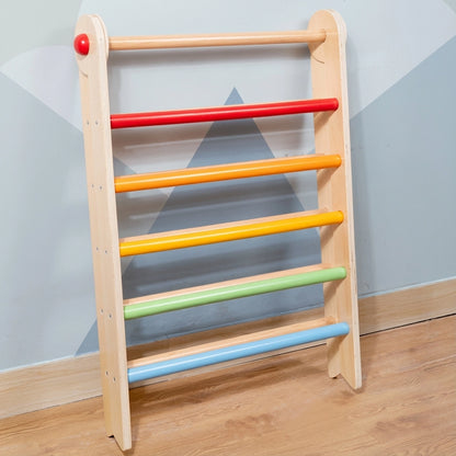 Folded plywood Montessori climbing triangle leaning vertically against a wall for compact storage