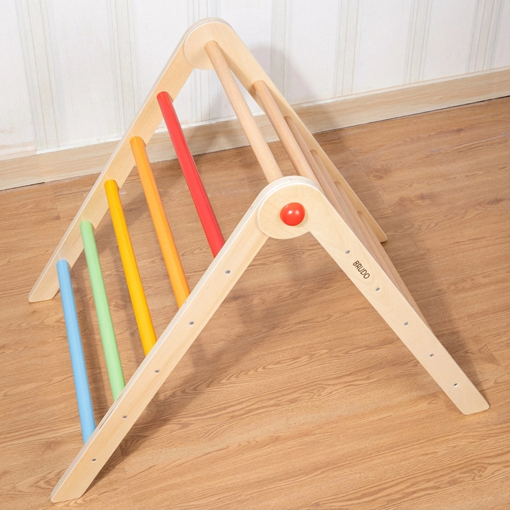 High-angle view looking down at a plywood Montessori climbing triangle with colorful rungs on a wood floor
