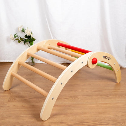 Angled front view of a plywood Montessori toddler climbing arch with natural wood and colored rungs