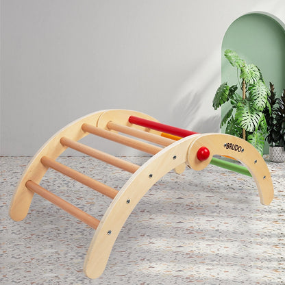 Plywood Montessori toddler climbing arch set up on a terrazzo floor in a room with a green arch wall