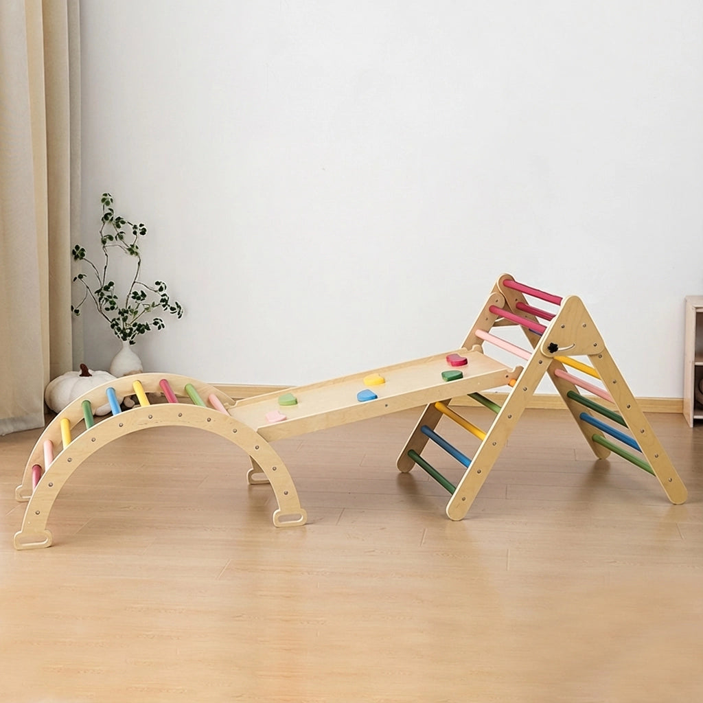 Plywood Montessori toddler climbing set with rainbow-colored rungs and rock climbing holds on the ramp