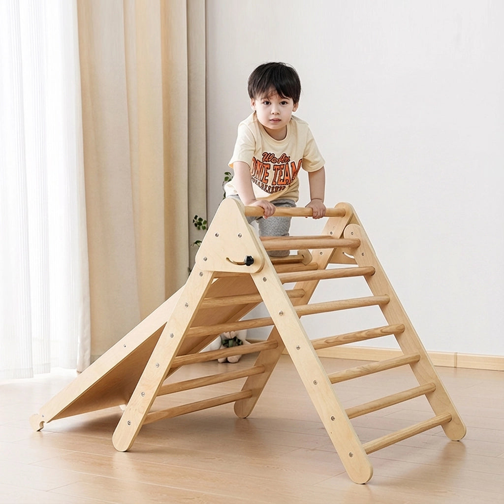 Toddler boy climbing a natural plywood Montessori triangle climber with an attached ramp
