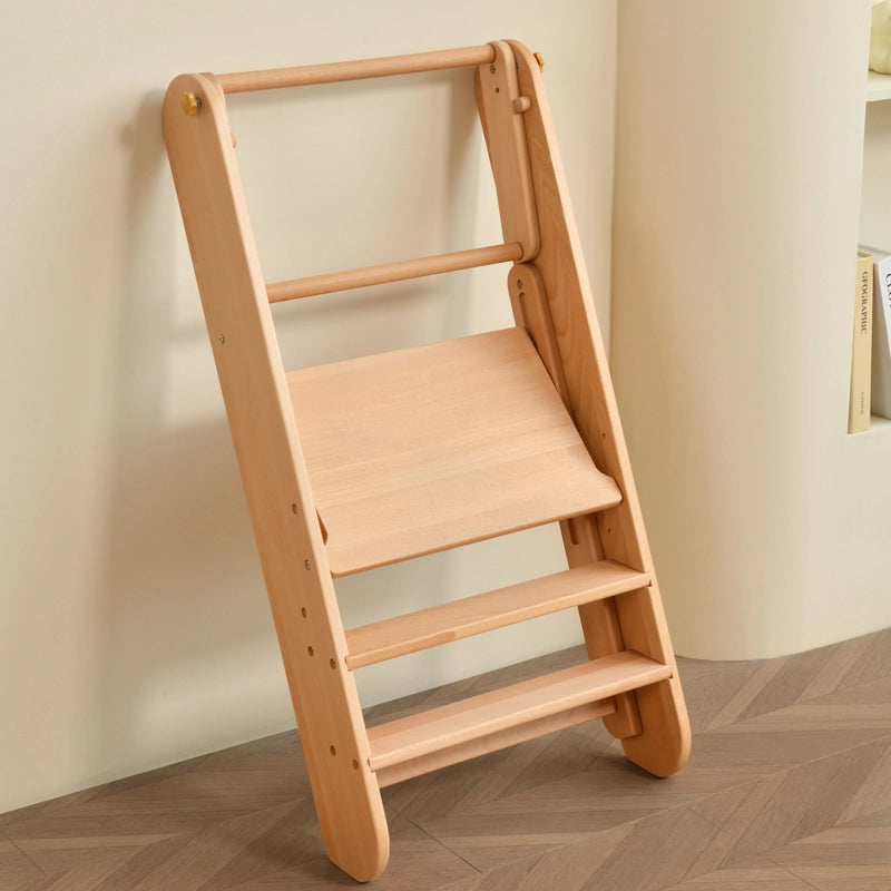 Folded solid beech wood Montessori toddler step stool leaning against a wall