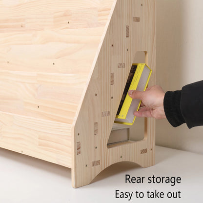 Close-up of a hand accessing a book stored in the rear compartment of the solid pine toddler bookshelf