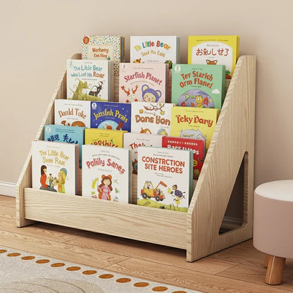 Three-quarter view of a solid pine toddler bookshelf filled with picture books