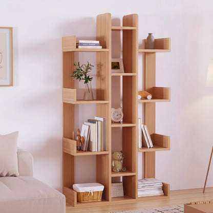 Front view of a solid pine geometric tree bookshelf displaying books and decorative items in a modern living room beside a sofa