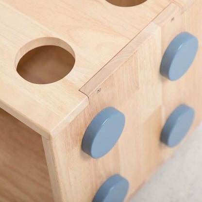 Close-up detail of the blue round connector pegs on the side of the solid rubberwood kids bookshelf