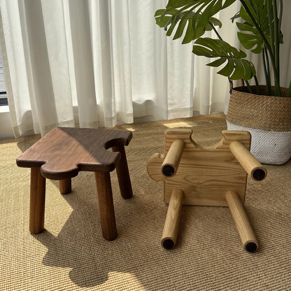 One upright stool and one overturned stool showing the underside construction and sturdy solid wood legs
