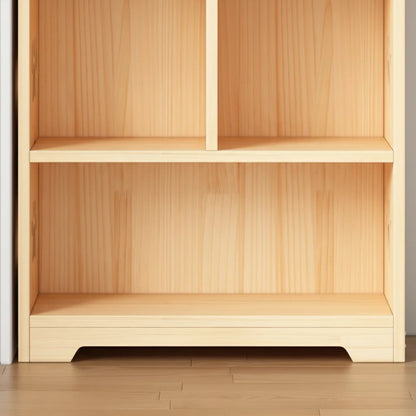 Close-up of the empty lower open compartments and base structure of a solid pine toy cabinet