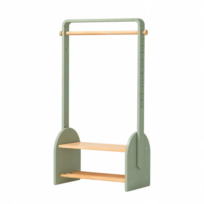Angled view of a sage green children's clothing rack with a height scale and lower storage shelf