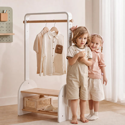 Front view of the white kids coat rack with a built-in height scale as two children stand beside it