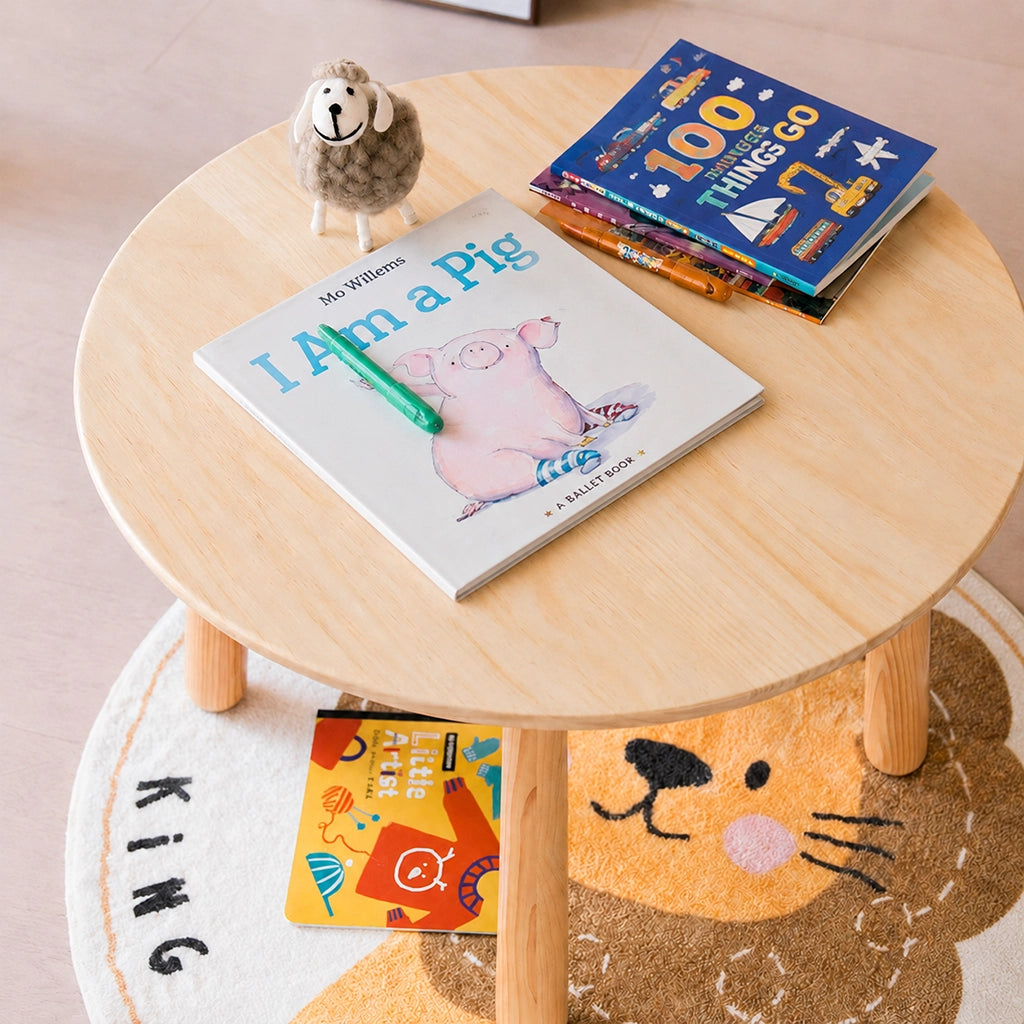 Close-up high angle view of a solid pine kids tabletop with storybooks, crayons, and a toy sheep