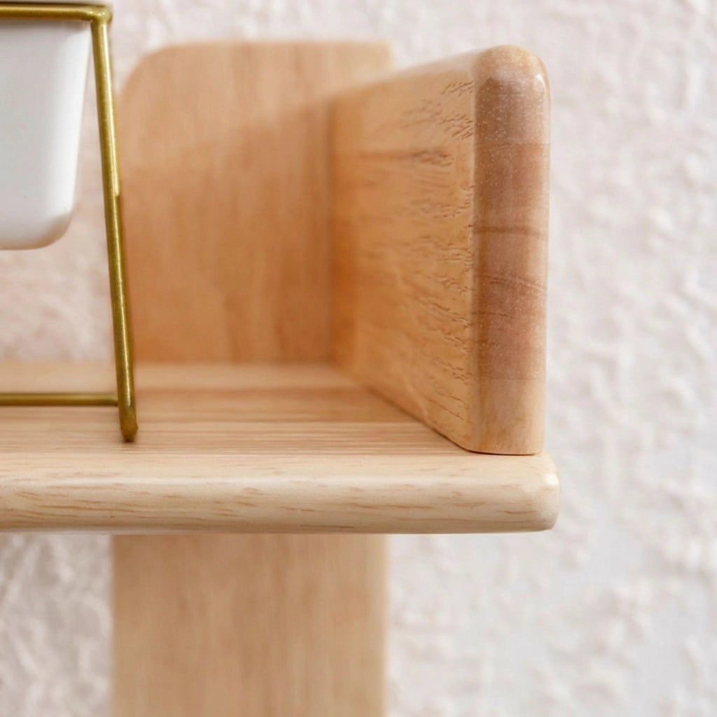 Detailed view of the smooth rounded corner and clear wood grain on a kids tree bookshelf shelf