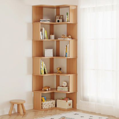 Angled view of a six-tier L-shaped corner bookshelf in a natural wood finish filled with books and toys