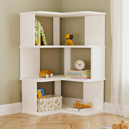 Three-tier white L-shaped corner bookshelf filled with books and toys against an olive green wall
