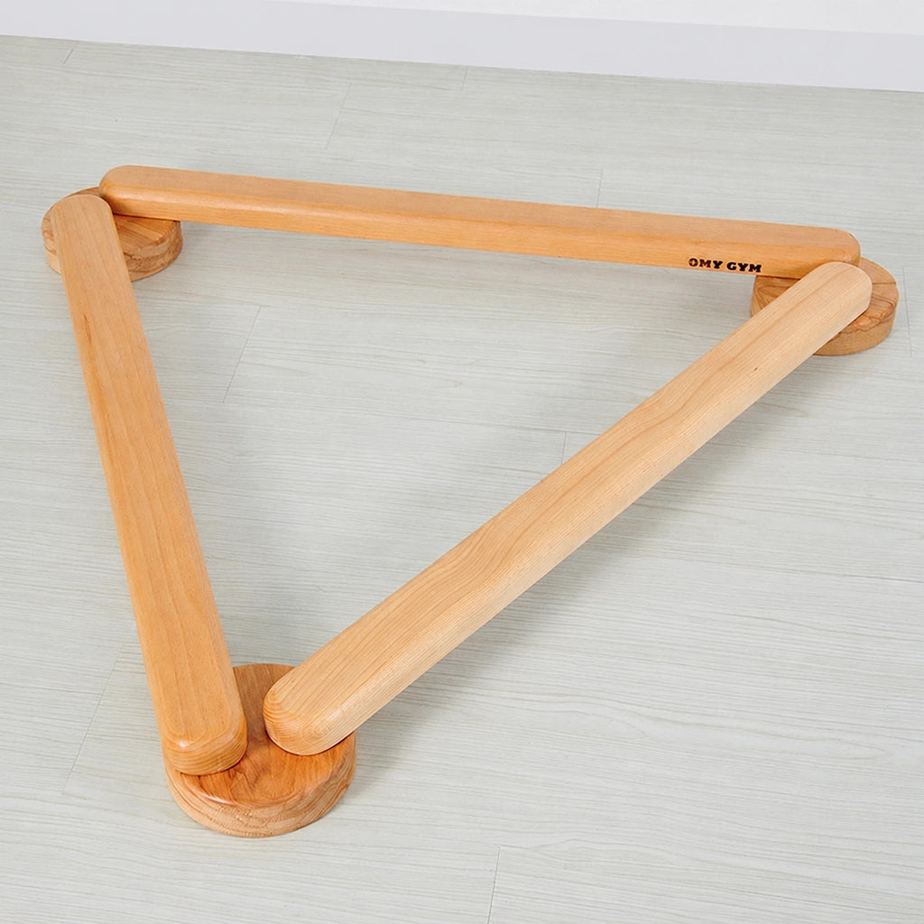 Triangular arrangement of a modular solid beech wood balance beam set on a wood floor