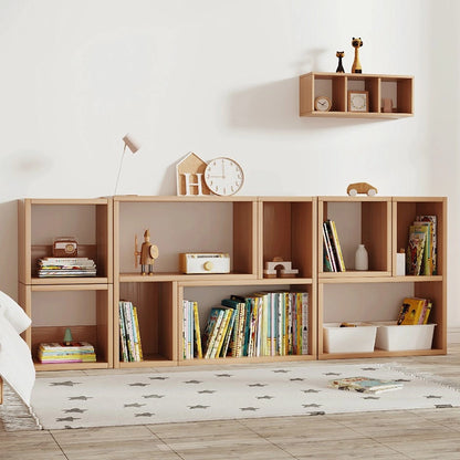 Wide view of solid pine Montessori storage cubes lined up against a wall with a matching wall shelf above