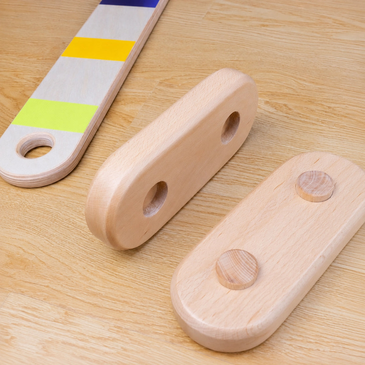 Close-up view of wooden base supports with connector pegs for balance beams