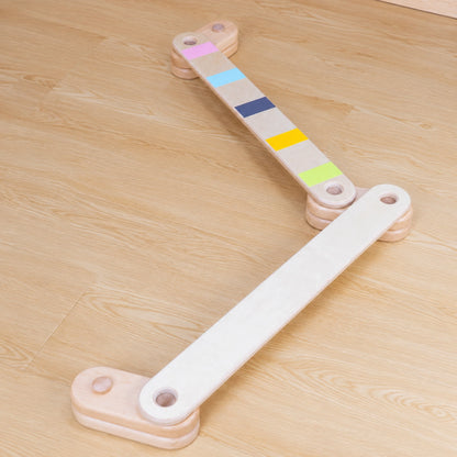 Modular wooden balance beam set arranged in a zigzag layout on a wood floor