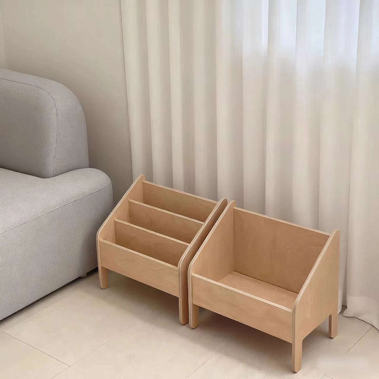 Two matching wooden Montessori storage units including a tiered bookshelf and an open toy storage bin