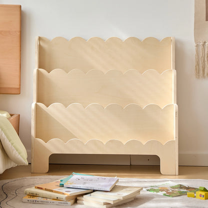 Front view of an empty plywood Montessori toddler bookshelf showing the natural wood finish and wavy shelves