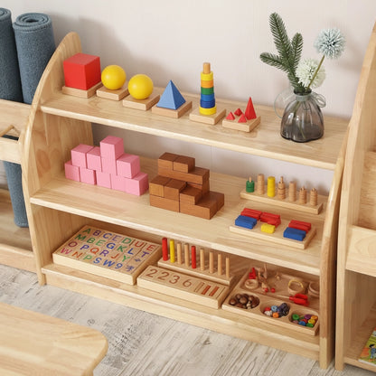 Close-up view of a Montessori toy shelf holding colorful blocks, geometric sorting shapes, and a small flower vase