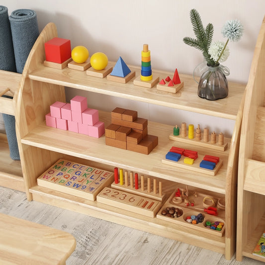 Close-up view of a Montessori toy shelf holding colorful blocks, geometric sorting shapes, and a small flower vase