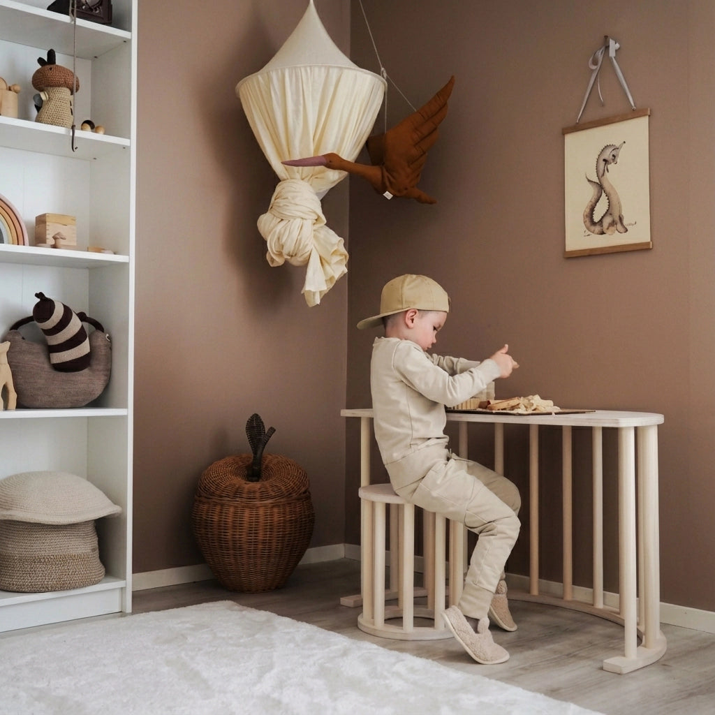 A young boy sitting on a wooden stool at a children's desk structure made from the wooden arch component