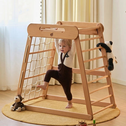 Toddler boy climbing the wooden rungs inside a solid beechwood climbing gym structure