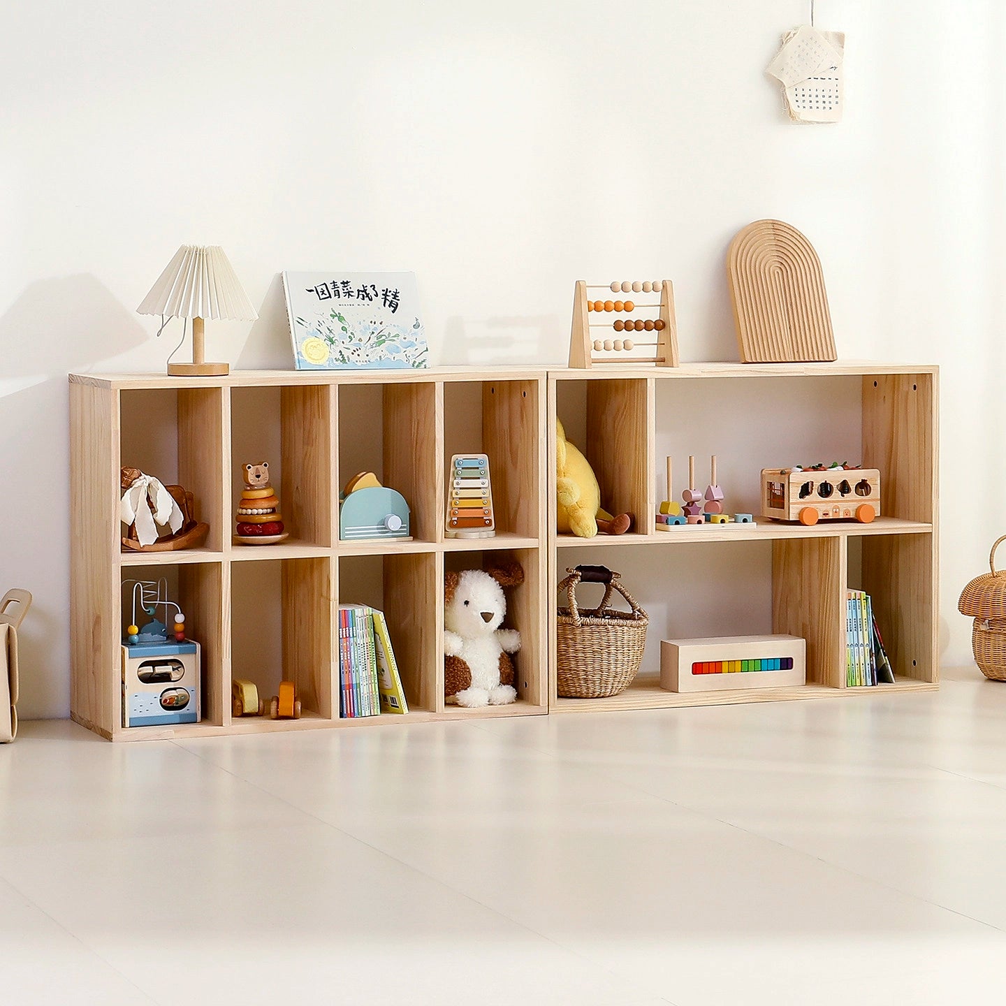 Front view of two lower two-tier wooden cubby organizers arranged side-by-side with toys and books