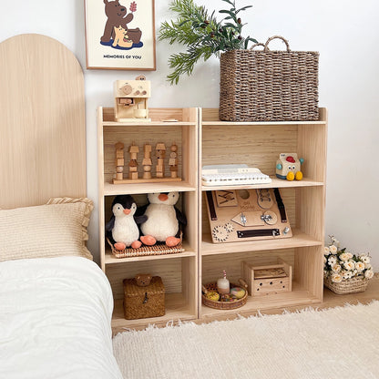 Front-angled view of the solid pine storage shelf displaying a wooden busy board and plush penguins