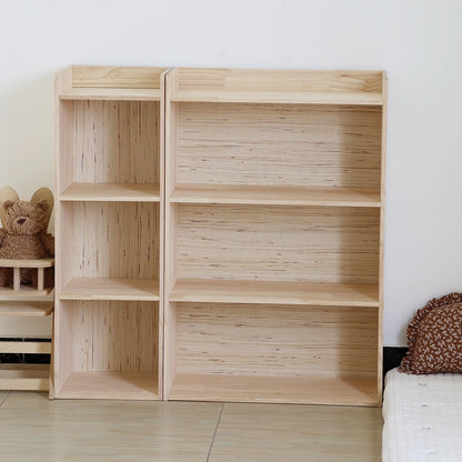 Front view of the empty solid pine Montessori toddler storage shelf against a white wall